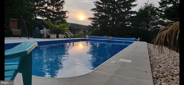 a view of swimming pool with a patio