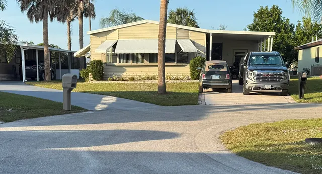 a view of a house with backyard and sitting area
