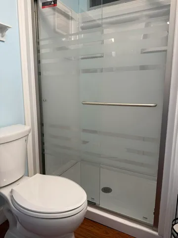 a bathroom with a toilet and a shower