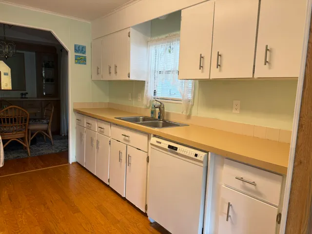a kitchen with granite countertop white cabinets and white appliances