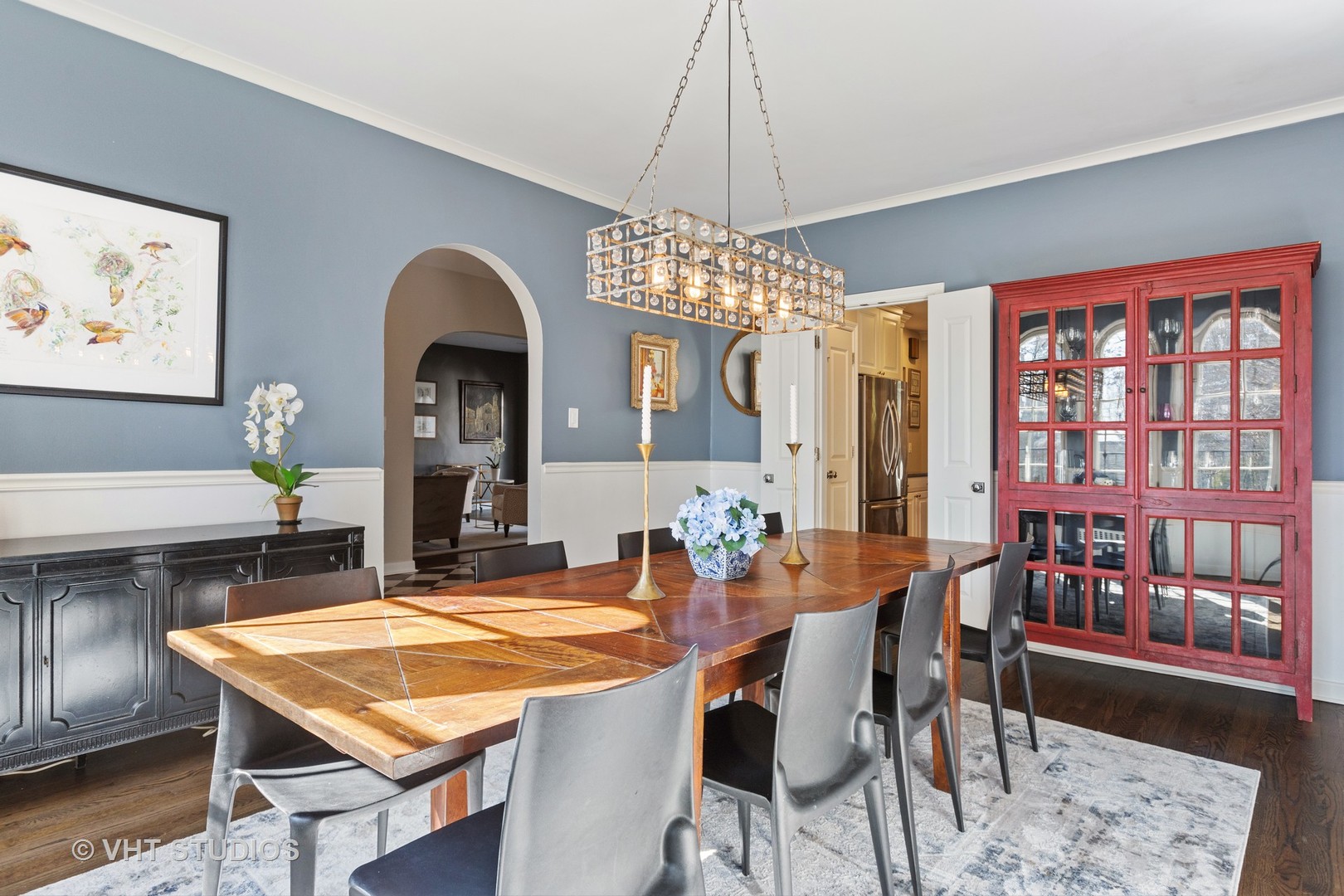 128 Church Road Winnetka, IL 60093 - Photo 11 of 46 a dining room with wooden floor a chandelier a wooden table and chairs