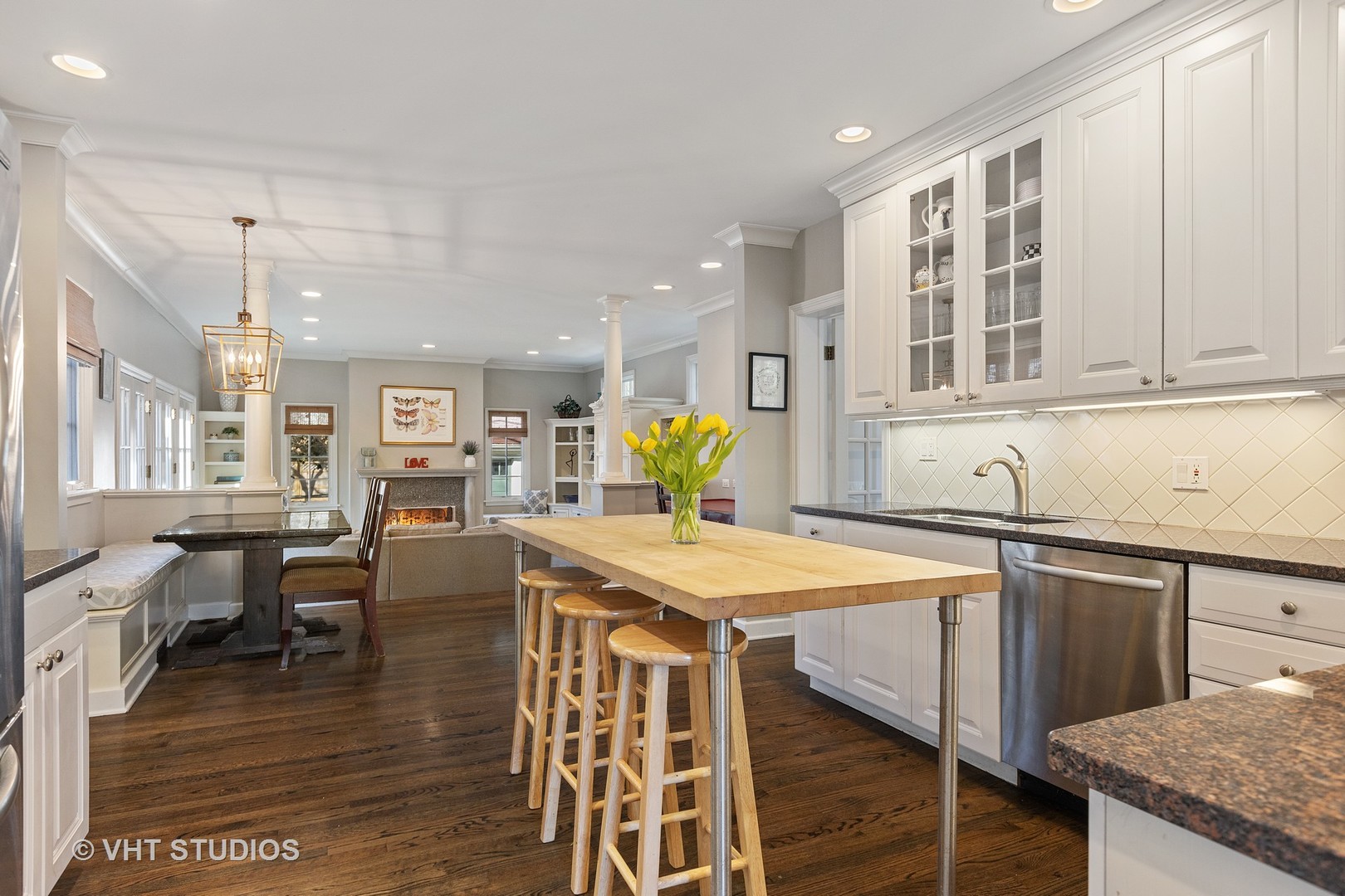 128 Church Road Winnetka, IL 60093 - Photo 12 of 46 a kitchen with stainless steel appliances granite countertop a table chairs sink and cabinets