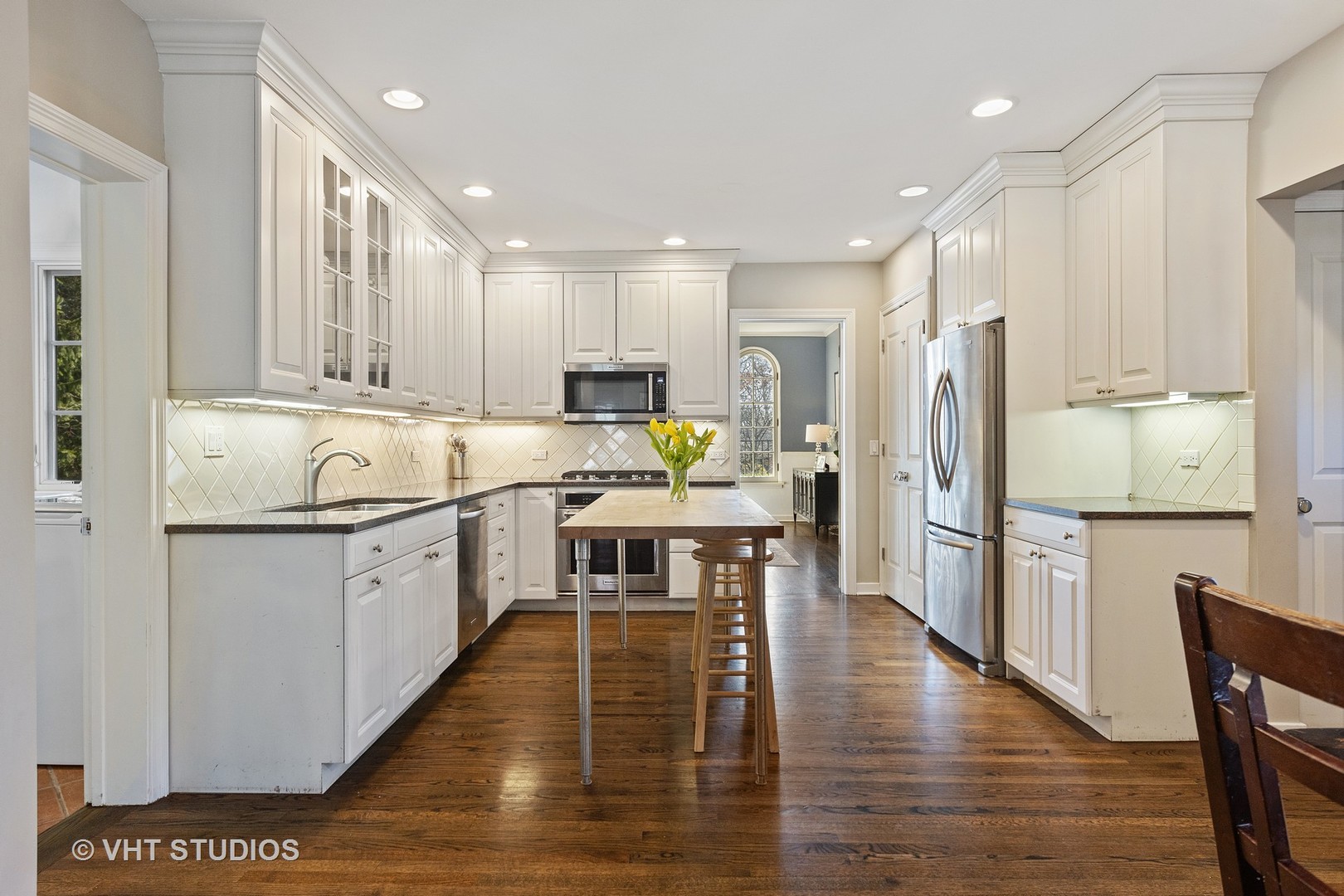 128 Church Road Winnetka, IL 60093 - Photo 13 of 46 a kitchen with a refrigerator a sink and wooden cabinets