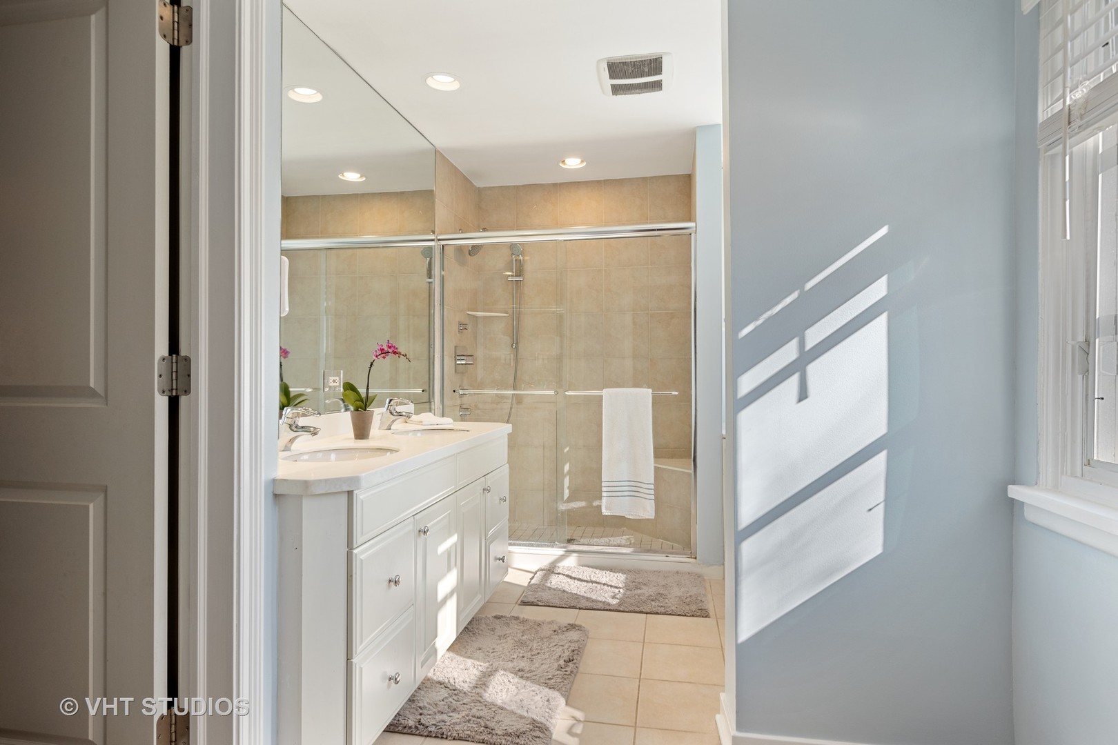 128 Church Road Winnetka, IL 60093 - Photo 28 of 46 a bathroom with a double vanity sink and mirror