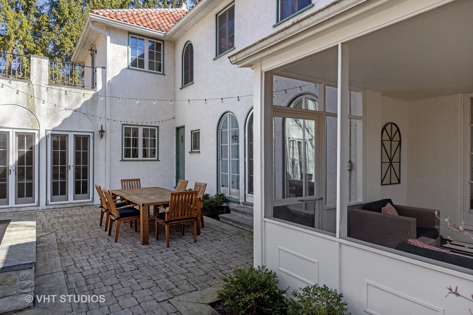 128 Church Road Winnetka, IL 60093 - Photo 36 of 46 a view of a house with a chairs and table in a patio