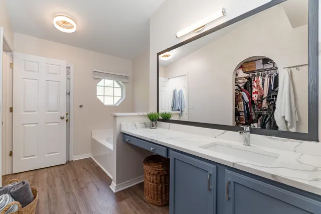 a bathroom with double vanity sinks and a mirror