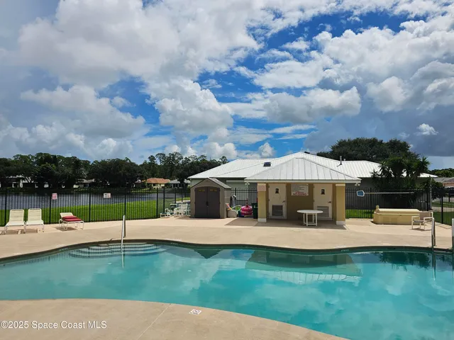 a view of a house with swimming pool and sitting area
