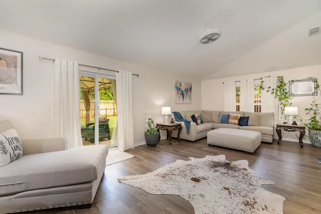 a bedroom with furniture and wooden floor