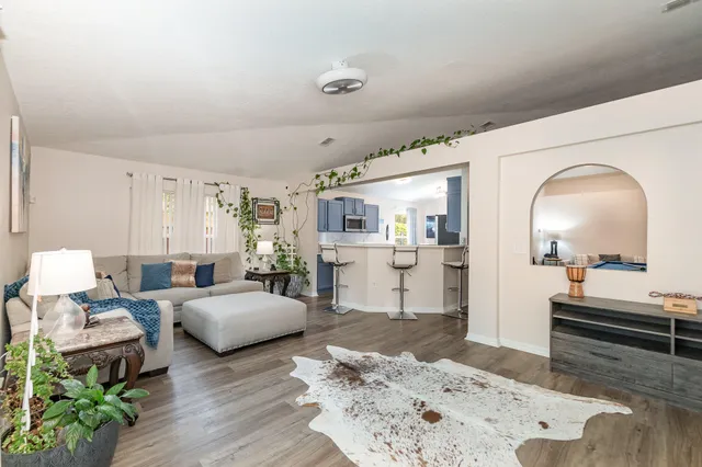 a living room with furniture and wooden floor