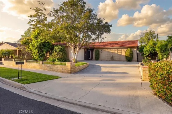 a view of a house with a yard and garage