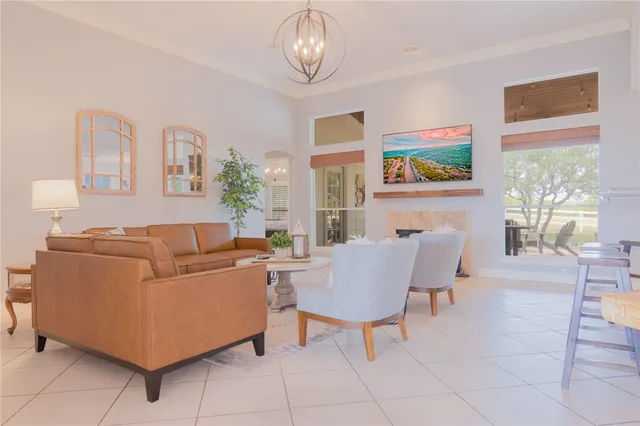 a living room with furniture a dining table and a bookshelf with wooden floor