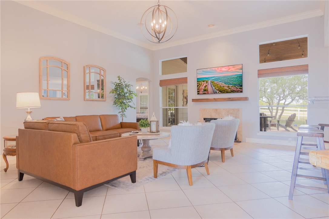 550 Hays Country Acres Road Dripping Springs, TX 78620 - Photo 11 of 40 a living room with furniture a dining table and a bookshelf with wooden floor