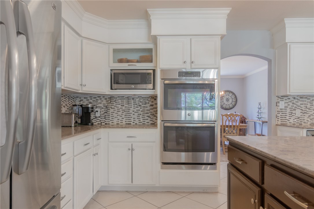550 Hays Country Acres Road Dripping Springs, TX 78620 - Photo 12 of 40 a kitchen with granite countertop a sink and a stove top oven