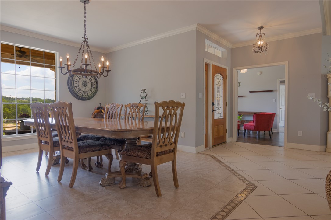 550 Hays Country Acres Road Dripping Springs, TX 78620 - Photo 15 of 40 a view of a dining room with furniture window and wooden floor