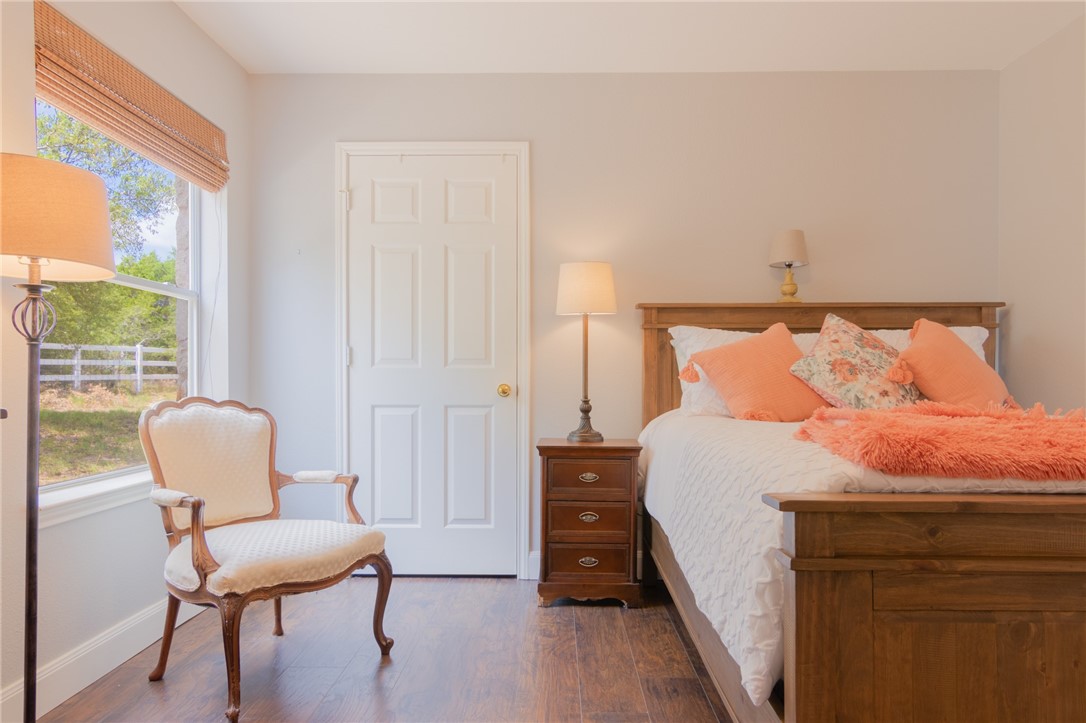 550 Hays Country Acres Road Dripping Springs, TX 78620 - Photo 21 of 40 a bedroom with a bed and a chair
