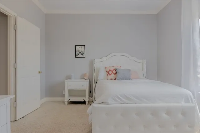 a bedroom with a bed and a chair