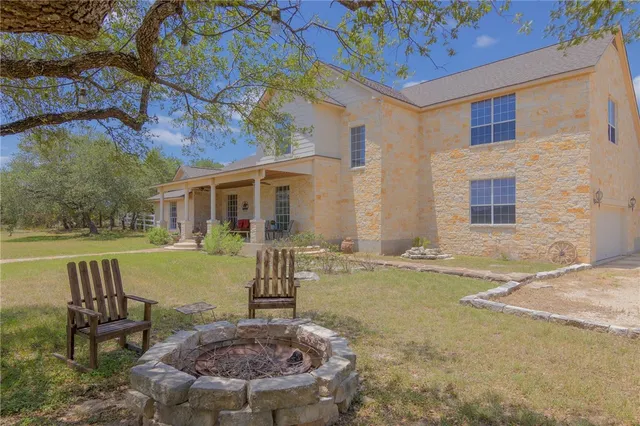 a view of a house with backyard porch and sitting area