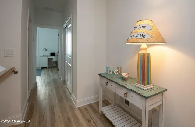 a view of a hallway view with wooden floor and staircase