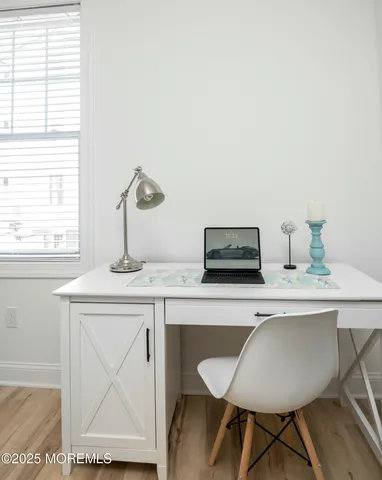 a living room with a table chairs and a window