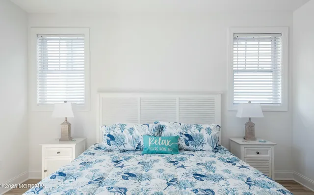 a large bed sitting in a bedroom next to a window