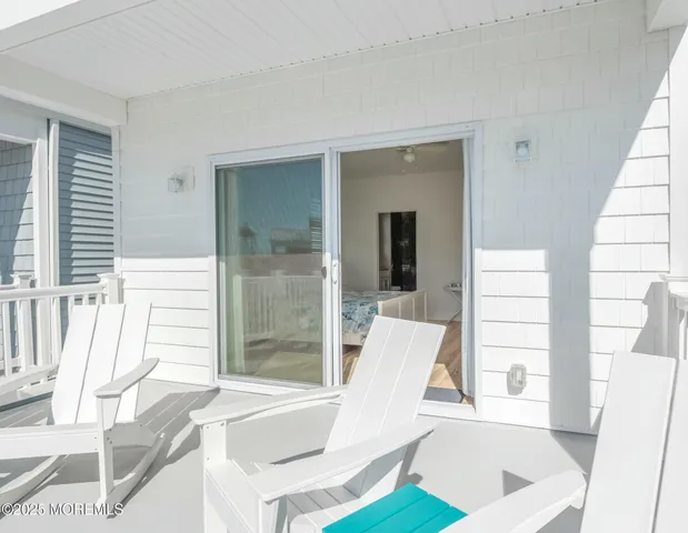 a view of a dining room with furniture and a large window