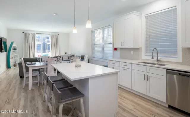a kitchen with a sink dining table and chairs