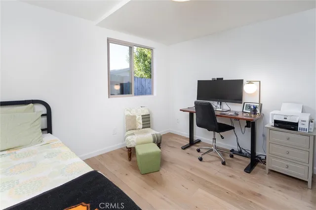 a dining room with furniture a chandelier and wooden floor