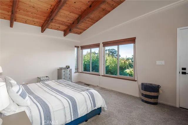 a view of a patio with table and chairs with wooden floor and fence