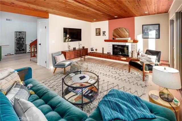 a living room with furniture a fireplace and a flat screen tv