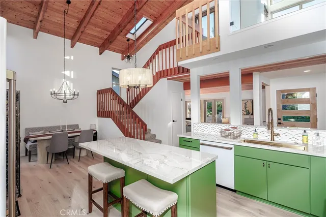 a kitchen with stainless steel appliances granite countertop a sink refrigerator and microwave