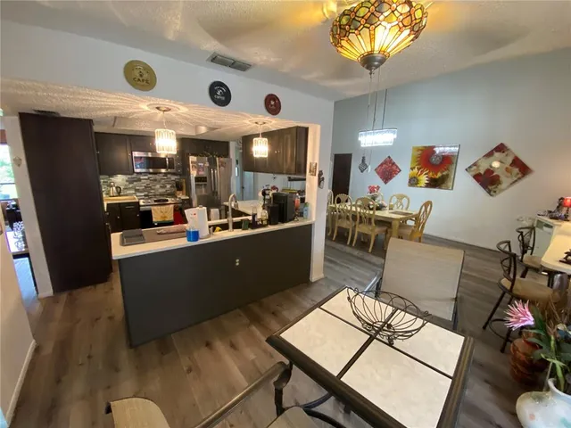a view of a dining room with furniture wooden floor and chandelier