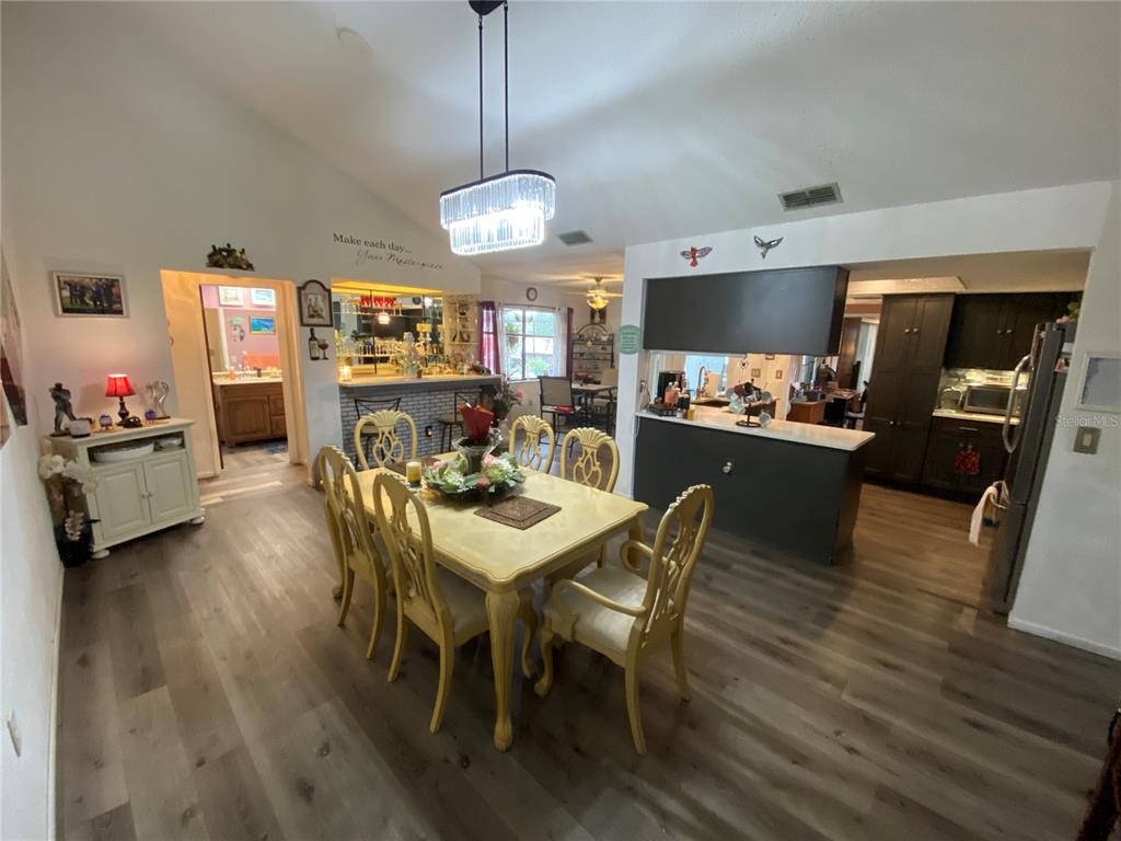 4100 Montano Avenue Spring Hill, FL 34609 - Photo 21 of 59 a view of a dining room with furniture wooden floor and chandelier