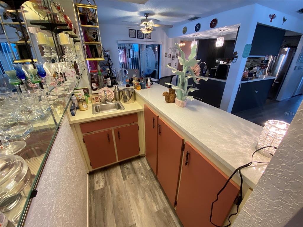 4100 Montano Avenue Spring Hill, FL 34609 - Photo 23 of 59 a kitchen that has a sink and a stove in it