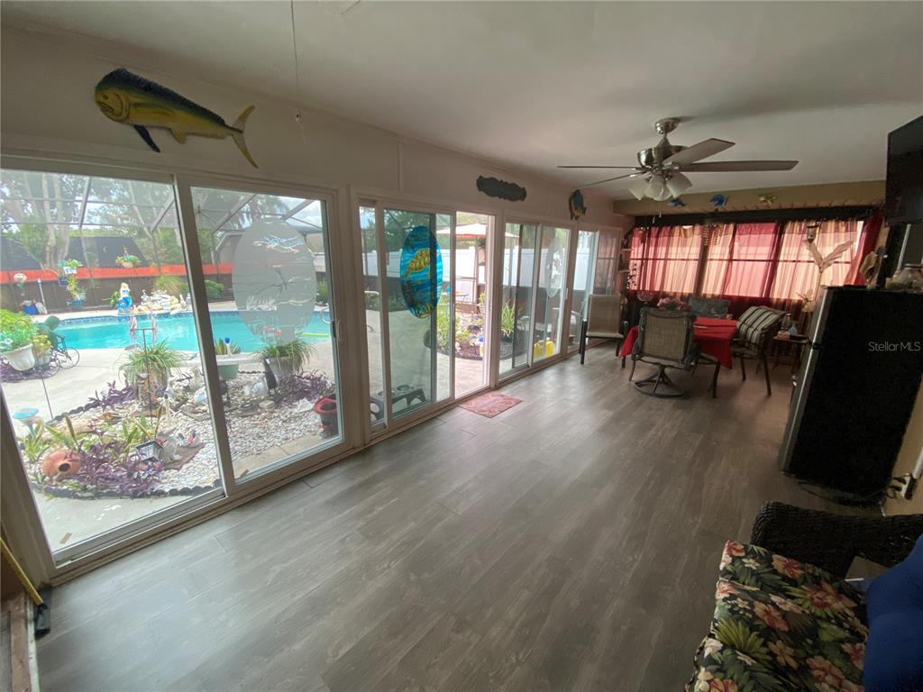 4100 Montano Avenue Spring Hill, FL 34609 - Photo 24 of 59 a view of livingroom with furniture wooden floor and a floor to ceiling window
