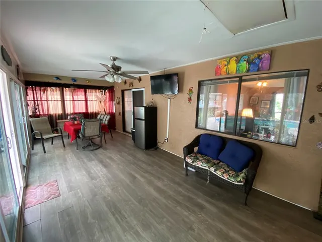 a living room with furniture and a floor to ceiling window