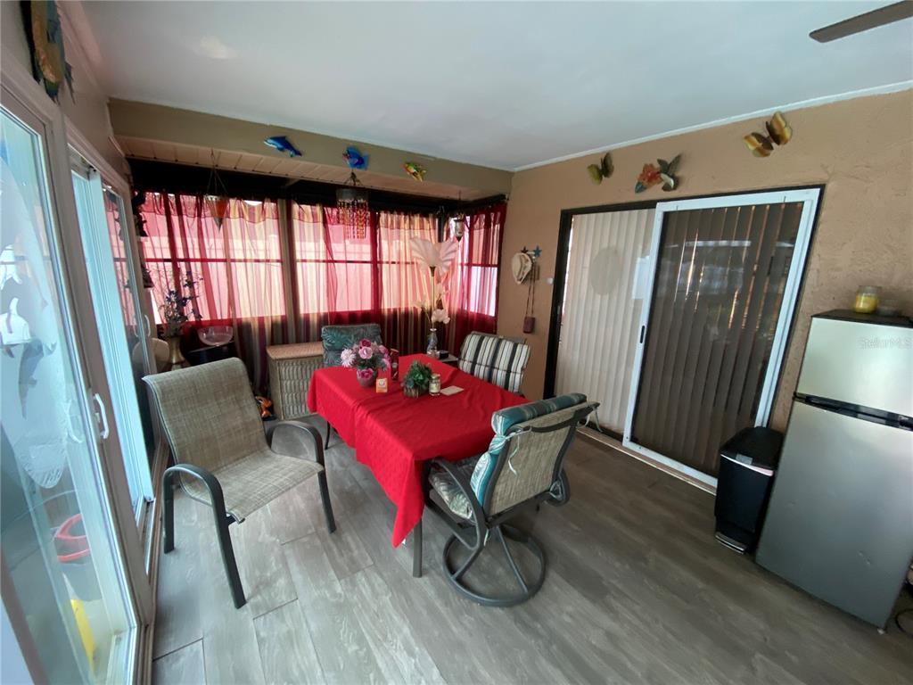 4100 Montano Avenue Spring Hill, FL 34609 - Photo 26 of 59 a living room with furniture window and wooden floor