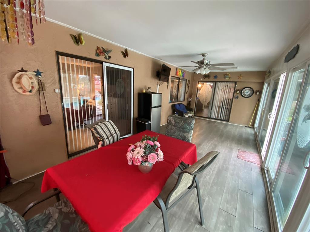 4100 Montano Avenue Spring Hill, FL 34609 - Photo 27 of 59 a living room with furniture a rug and kitchen view