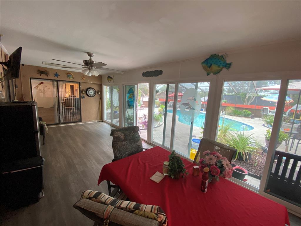 4100 Montano Avenue Spring Hill, FL 34609 - Photo 28 of 59 a living room with furniture and a floor to ceiling window
