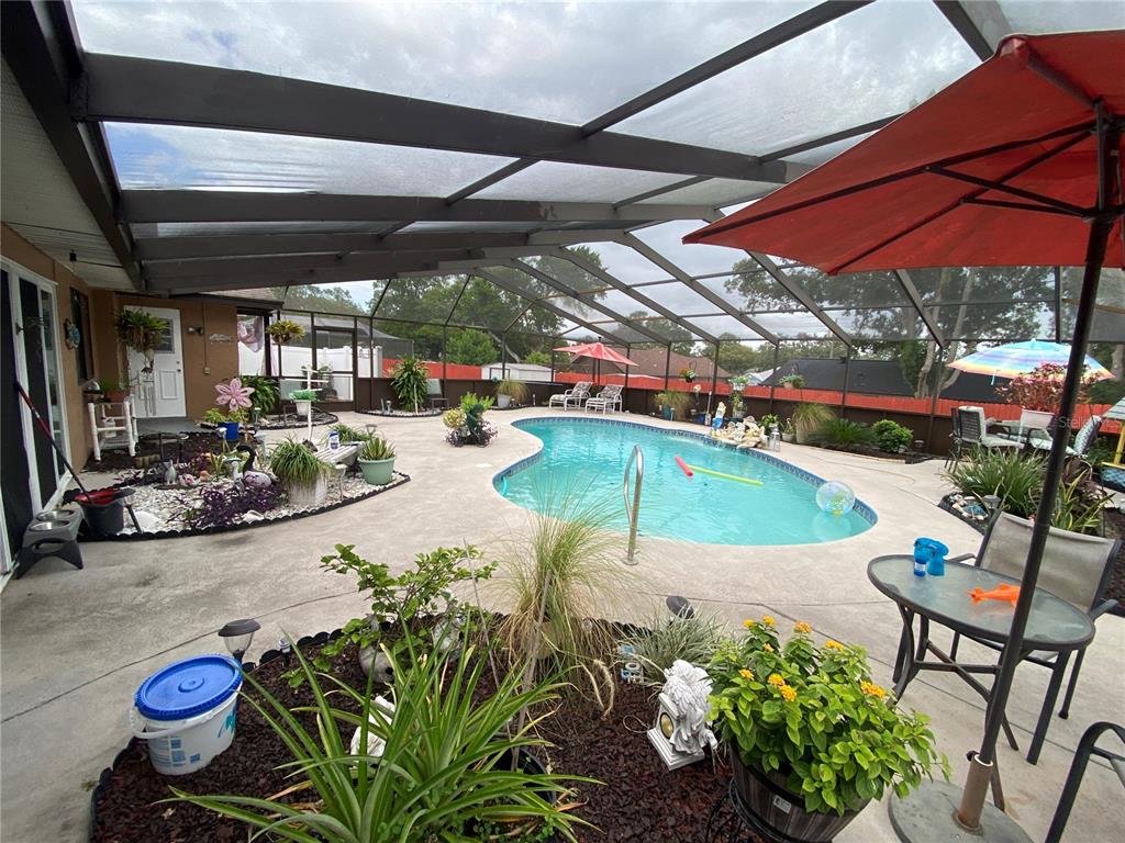 4100 Montano Avenue Spring Hill, FL 34609 - Photo 29 of 59 a view of a swimming pool with a patio