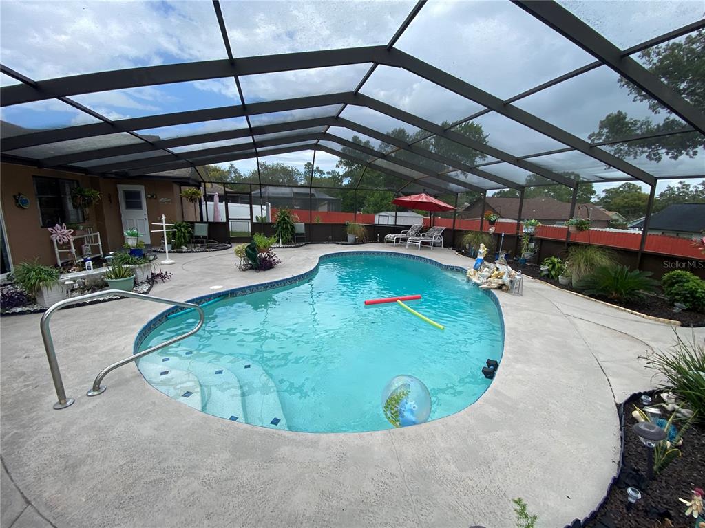 4100 Montano Avenue Spring Hill, FL 34609 - Photo 30 of 59 a view of a swimming pool with a patio