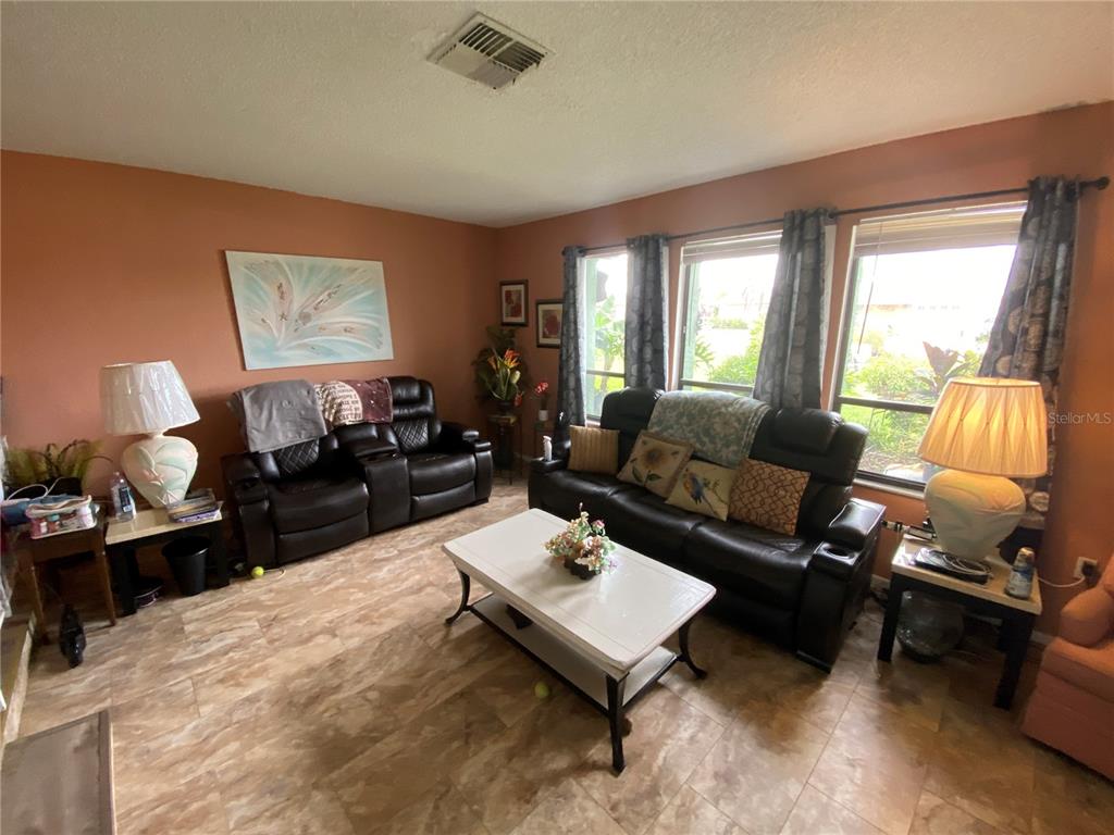 4100 Montano Avenue Spring Hill, FL 34609 - Photo 3 of 59 a living room with furniture and a large window