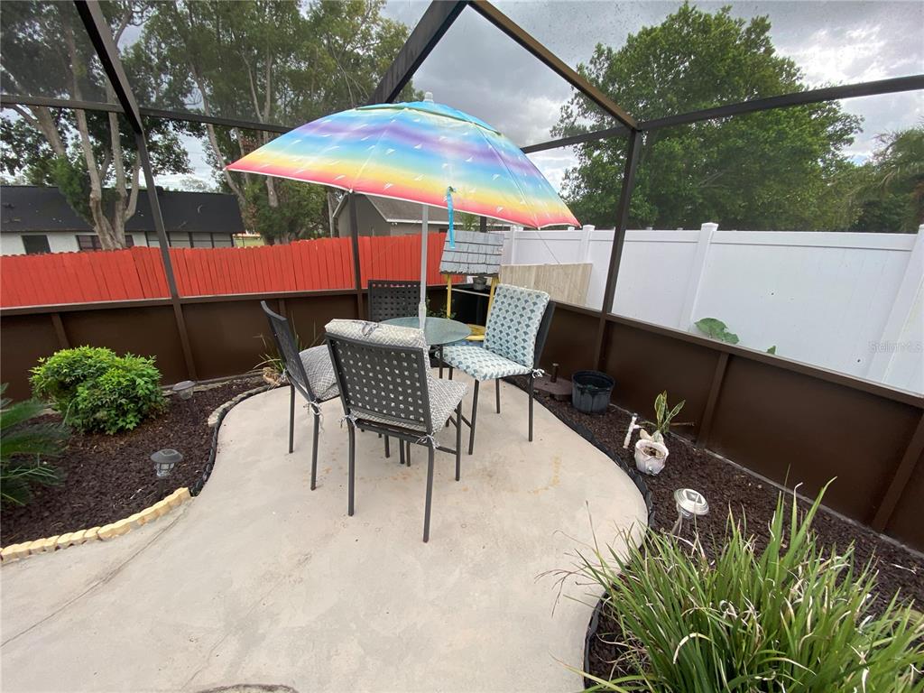 4100 Montano Avenue Spring Hill, FL 34609 - Photo 31 of 59 an outdoor space with patio table and chairs