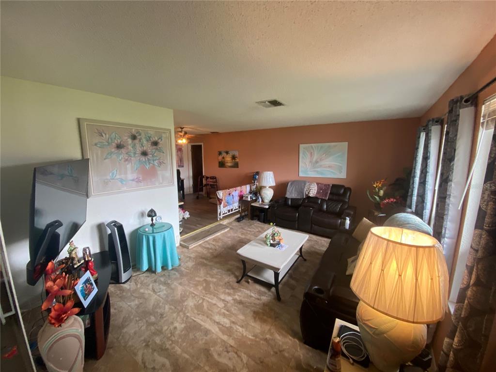 4100 Montano Avenue Spring Hill, FL 34609 - Photo 38 of 59 a living room with furniture and wooden floor