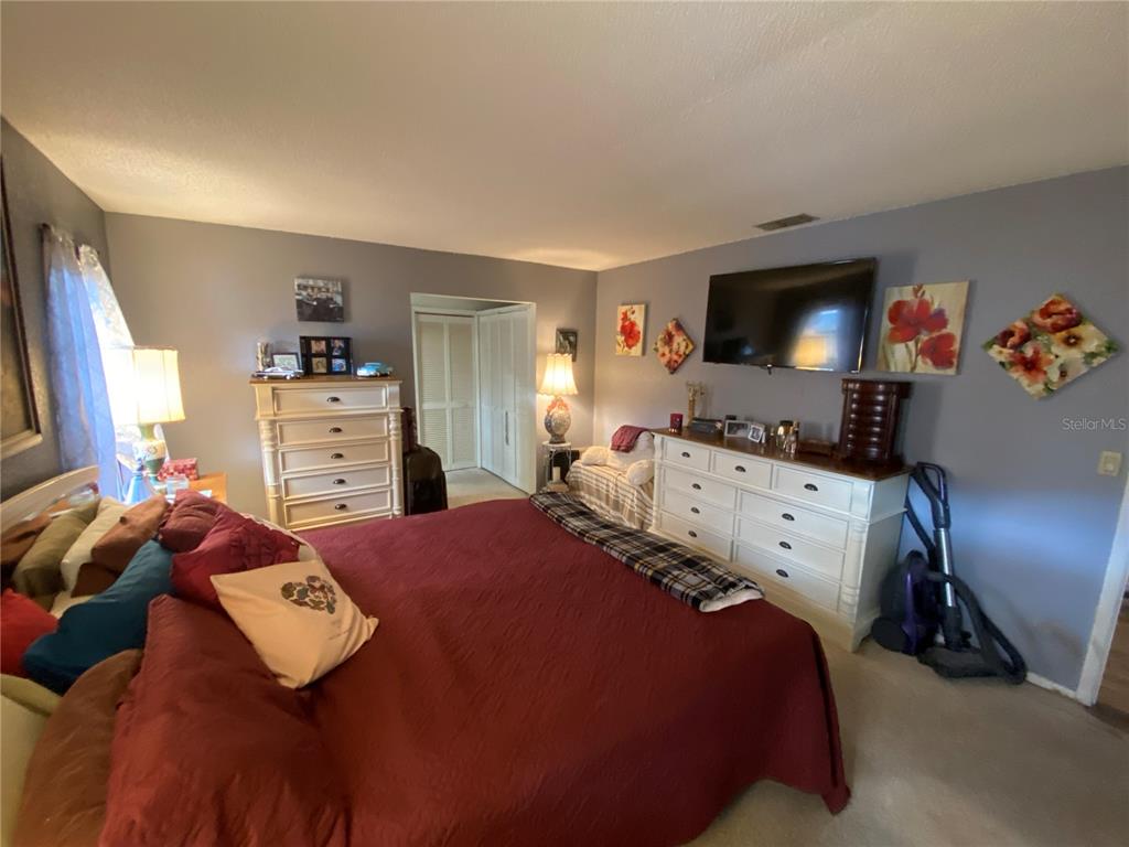 4100 Montano Avenue Spring Hill, FL 34609 - Photo 40 of 59 a bedroom with a bed and furniture