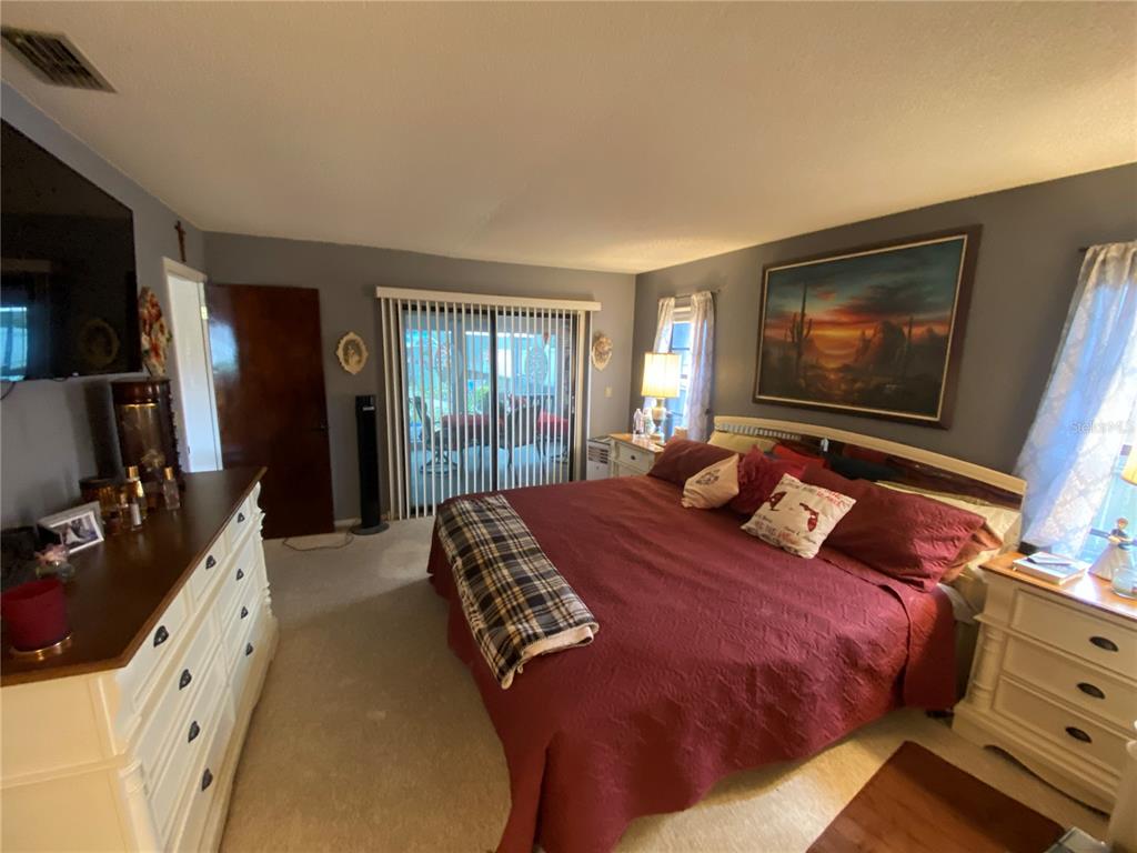 4100 Montano Avenue Spring Hill, FL 34609 - Photo 41 of 59 a bedroom with a bed and a flat screen tv