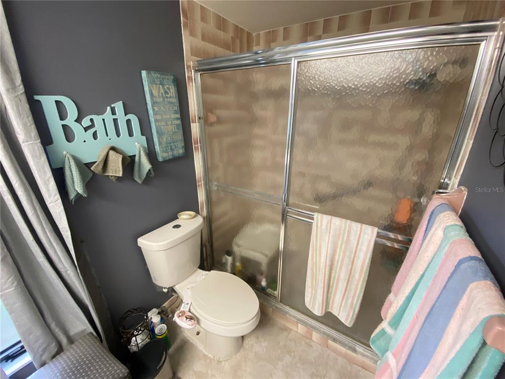 4100 Montano Avenue Spring Hill, FL 34609 - Photo 44 of 59 a white toilet sitting next to a small bathroom