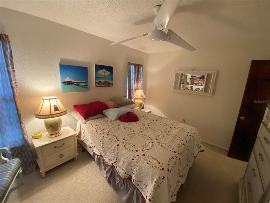 4100 Montano Avenue Spring Hill, FL 34609 - Photo 48 of 59 a bedroom with a bed and a tv on the dresser