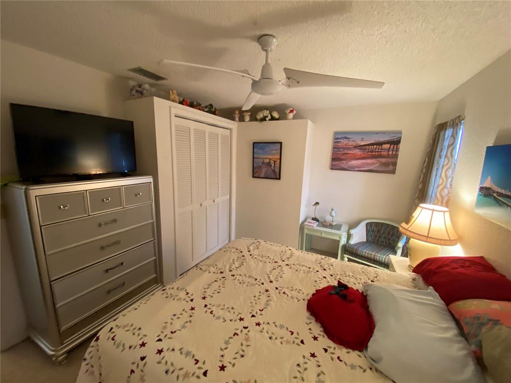 4100 Montano Avenue Spring Hill, FL 34609 - Photo 50 of 59 a bedroom with a bed and a flat screen tv