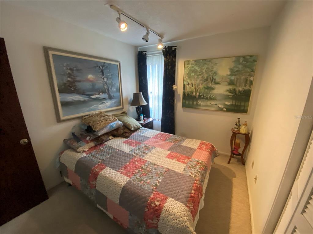 4100 Montano Avenue Spring Hill, FL 34609 - Photo 51 of 59 a bedroom with a bed and a painting on the wall