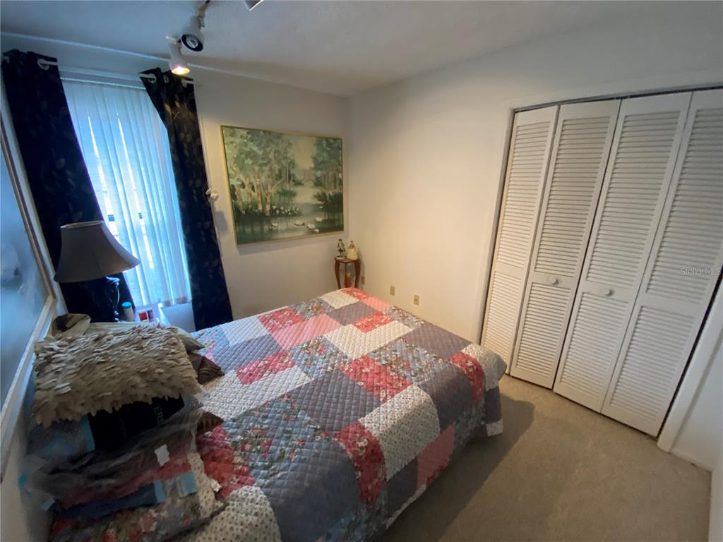 4100 Montano Avenue Spring Hill, FL 34609 - Photo 52 of 59 a bedroom with a bed and a mirror